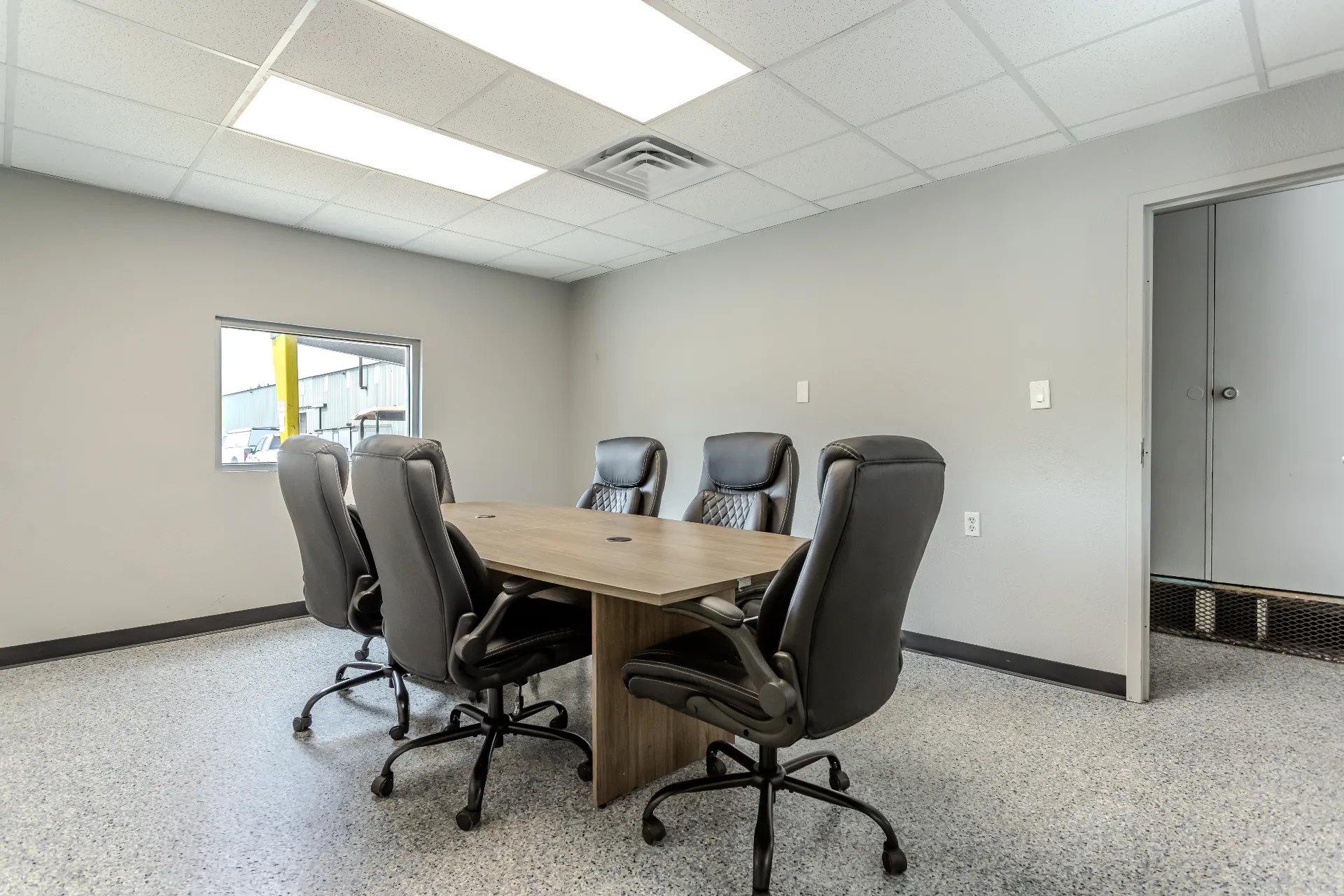 New conference room built as part of the NE 28th St buildout with laminate table, executive chairs, and interior vision window