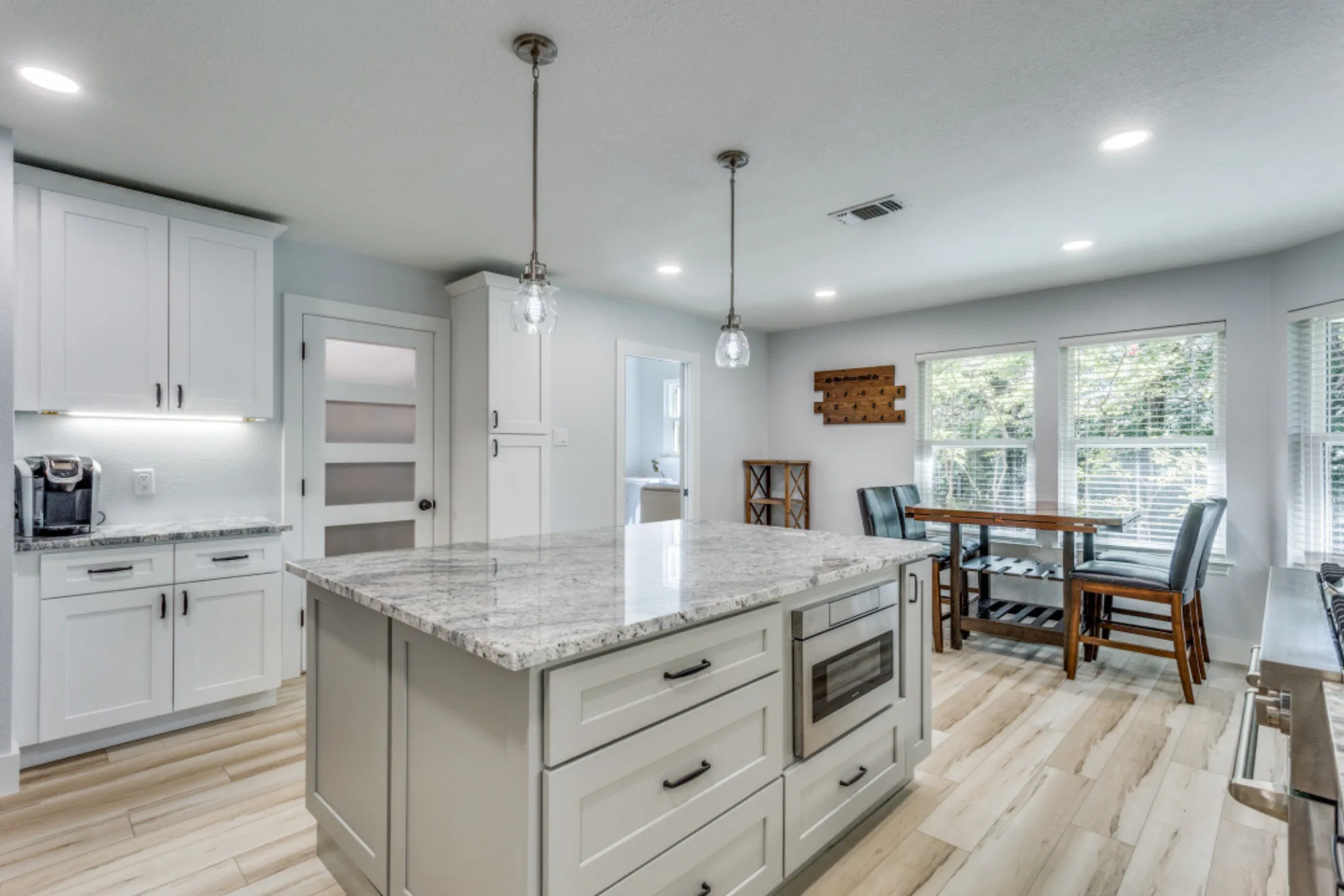 Renovated kitchen with white shaker cabinets and granite countertops on High Cliff Dr