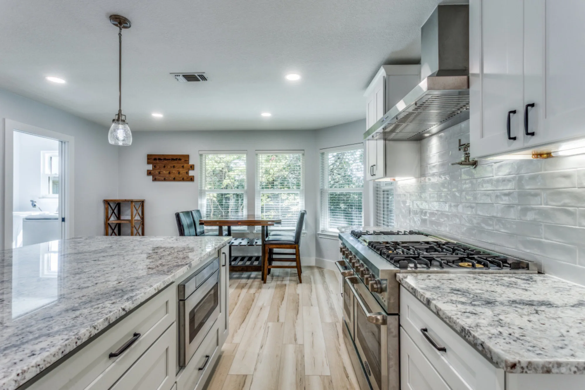 Open-concept kitchen and living area with hardwood floors after remodel